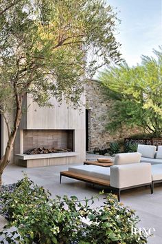 an outdoor living area with couches and trees