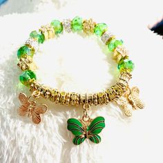 Butterfly Stretchy Green Gold Bracelet Casual Charm Bracelet For Party, Casual Gold Beaded Bracelets For Party, Bohemian Metal Bracelets For Spring, Spring Bohemian Metal Bracelets, Spring Beaded Bracelet For Parties, Green Spring Party Jewelry, Green Bangle Bracelet For Spring, Green Bracelets For Spring Gift, Adjustable Casual Crystal Bracelet