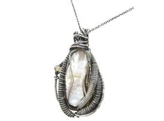 This gorgeous, handcrafted pendant was made with a white, cultured, Biwa stick pearl with rich sheen, set in solid Sterling silver wire with three fiery, Ethiopian welo opals in delicate herringbone weaves. The wire was oxidized naturally with egg yolk. This piece comes suspended on your choice of chain and measures 45x25x16mm (1.8" x 1.0" x 0.6"). This is a one-of-a-kind item and there won't ever be another like it! This piece comes in a luxurious, black velvet jeweler's box, contained in a car Jordan Jewelry, The Wire, Egg Yolk, Welo Opal, White Pearl, Pearl Pendant, Silver Wire, Ethiopian Opal, Sterling Silver Chains