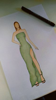 a drawing of a woman in a green dress on top of a piece of paper