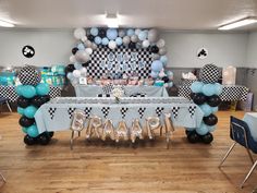 a table with balloons and decorations for a baby shower