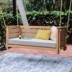 a porch swing with cushions on it