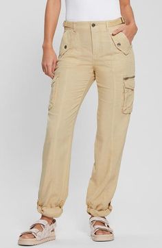 Rock a modern, casual-cool vibe in these lightweight cargo pants designed with belted sides and roll-tab cuffs. 30" inseam; 8" leg opening; 10 1/2" front rise; 15" back rise Zip fly with button closure Front slant pockets with decorative flaps; cargo bellows flap pockets; back flap pockets; back zip pocket Adjustable buckle side tabs Roll-tab cuffs Partially lined 70% lyocell, 30% linen Machine wash, tumble dry Imported Spring Mid-rise Cargo Pants With Flap Pockets, Fall Cargo Style Bottoms With Cuffed Ankles, Mid-rise Beige Fall Cargo Pants, Mid-rise Beige Cargo Pants For Fall, Beige Mid-rise Fall Cargo Pants, Fall Relaxed Fit Cargo Pants With Cuffed Ankles, Fitted Beige Cargo Pants With Belt Loops, Mid-rise Bottoms With Flap Pockets For Spring, Spring Mid-rise Bottoms With Flap Pockets