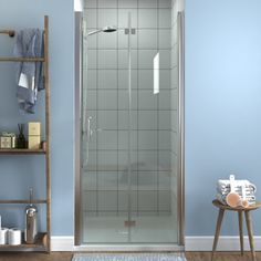 a bathroom with blue walls and white tile on the floor, including a walk in shower