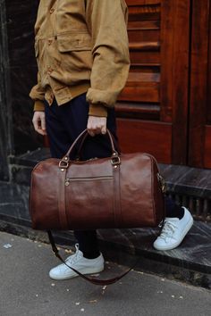 This handmade leather travel bag is made with 100% natural full grain leather which is tanned with all natural materials. There is no chemical materials in this leather.  This bag is handmade in our studio in Milan.  The lining is 100% cotton and it is easy to clean.  All the HARDWARE are made by BRASS. they are real brass and not finishing by brass color. the quality is really high and we guarantee all of the hardwares. All the bags will come with a cotton dust bag which can protect the leather and bag when it is not in use.  In options u can find Protection cream to add to your purchase. It will make the bag waterproof and will renew it after some use.  Dimensions :  Wide: 52 Cm / 21  inches Hight: 29 Cm / 11.5 inches  Deep: 26 Cm / 10.5 inches  Handle drop: 15 Cm / 6inches Long adjustab Brown Smooth Grain Travel Bag For Weekend Trips, Brown Smooth Grain Duffle Bag For Weekend Trips, Brown Smooth Grain Duffle Bag For Overnight Trips, Bag Campaign, Leather Overnight Bag, Leather Duffel Bag, Leather Duffel, Sac Week End, Leather Travel Bag