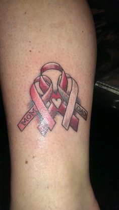 a woman's foot with two pink and red ribbons on it, the word hope is in the middle