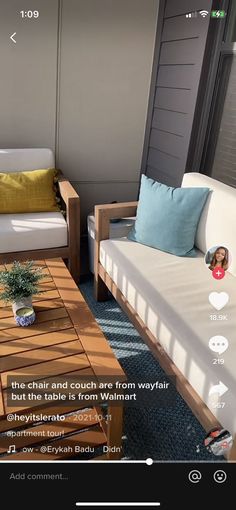 a living room with two couches and a coffee table in front of a window