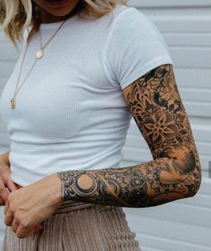 a woman with tattoos on her arm and arms