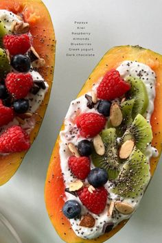 two pieces of fruit with nuts, kiwis, and berries on top are shown