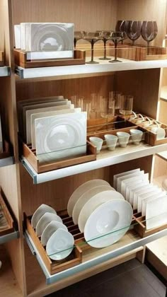 the shelves are filled with dishes and plates