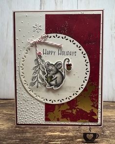 a card with a mouse on it and the words happy holidays written in white ink