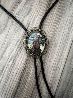 Our handmade western bolo tie has a vintage cowboy with a glass coating. PERFECT for a country men’s bolo tie, wedding sting tie, necktie for groomsmen, or any special person in your life. This bolo tie for men (and women!) has a metal clamp which makes it easy to adjust. *Makes a Great Gift*Pendant Size: 1.5 in x 1.25 inCord in Black Genuine Leather: 39in Western Lariat Bolo Tie With Adjustable Length, Western Jewelry With Adjustable Length For Rodeo, Western Style Lariat Bolo Tie With Adjustable Length, Adjustable Lariat Bolo Ties For Western-themed Events, Western Style Adjustable Jewelry For Western-themed Events, Western Jewelry With Adjustable Length For Western-themed Events, Western Bolo Ties For Western-themed Events, Western Bolo Ties With Adjustable Length, Western Bolo Ties With Adjustable Length For Western-themed Events