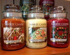 yankee candles are lined up on a shelf