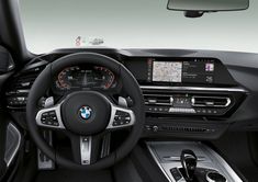 the interior of a bmw vehicle with its dashboard and infotains showing, including an electronic display