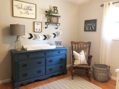 a baby's room with a dresser, crib and pictures on the wall