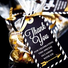 a black and white thank you tag with gold foiled candies in front of it