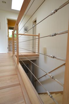 the inside of a house with wood and metal railings