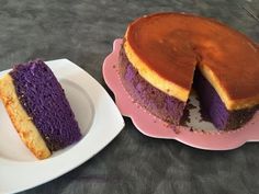 a purple and yellow cake sitting on top of a pink plate next to a white plate