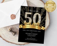 the 50th birthday party is set on top of a tree stump with an envelope and gold ribbon