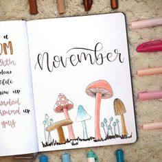 an open notebook with writing on it next to markers and pencils in the shape of mushrooms