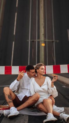 a man and woman sitting on the ground