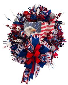 a patriotic wreath with an eagle, american flag and other decorations on it for the fourth of july