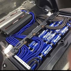 there are many cables in the back of a car that is packed with other items