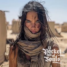 a woman with long hair and scarves on her face is standing in the desert