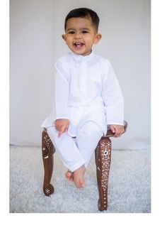 Adorable, made-to-order kurta for infants, toddlers, and kid boys! MATCHING FATHER AND SON SETS ARE AVAILABLE ON OUR SHOP Kurta ➤ Breathable and easy-to-wash cotton fabric ➤ Easy open and close clasp-buttons ➤ No-itch collar and sleeves ➤ Wide neck to easily fit over baby's head Pajama / Pant / Trouser ➤ Breathable and easy-to-wash cotton fabric ➤ White to match with several kotis, kurtas and occasions ➤ Stretchable elastic waistband Choti Koti kurtas are made without a nehru collar for our smal Wedding Pant Set With Dabka For Eid, Eid Wedding Pant Set With Dabka, Chikankari Embroidered Pant Set For Wedding And Eid, Bollywood Style Dabka Pant Set For Wedding, Long Sleeve Dabka Pant Set For Wedding, Long Sleeve Pant Set For Wedding With Dabka, Festive White Pant Set For Wedding, Traditional Festive Wedding Pant Set, Traditional Fitted Pant Set For Eid