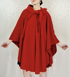 This incredible vintage cape is perfect for any Winter wardrobe. The bright red really adds a nice bright pop of color to the dreary winter. The piece is open - meaning no sleeves or slots for your arm. There is also a hood with ties to fasten around the neck should you choose. Fabric feels like a type of fleece in terms of weight. Please see image for fiber content. Label for "Hourihan". Open size. Model is modern size 4/6. FREE SHIPPING Measurements (when buttoned): Bust: open Waist: open Hips Open Hips, Cape With Hood, Bright Pop, Vintage Cape, Red Cape, Hooded Cape, Dress Form, Winter Wardrobe, Bright Red