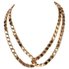 This 19 karat gold handmade gold can be worn in a variety of ways It is long enough to be wrapped around the neck two; three or four times. It can also be tied as a lariat. The necklace is a richly colored gold. It does not have a clasp. The links consist of overlapping double circles topped with an oval set on a diagonal which is an unusual design. The necklace weighs a substantial 120 grams. Gold-tone Lariat Chain Necklaces, Party Lariat Chain Necklace With Double Chain, Formal Lariat Long Necklace With Adjustable Chain, Party Lariat Double Chain Necklace, Formal Long Lariat Necklace With Adjustable Chain, Gold Lariat Clavicle Chain Necklace, Long Chain Lariat Necklace For Formal Occasions, Formal Gold Lariat Chain Necklace, Luxury Multi-strand Gold Necklace