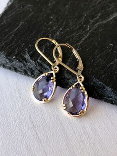 Amethyst Earrings, February Birthstone, Purple Teardrop Gem Earrings in Gold or Silver, Purple Jewelry, Lavender Earrings, Gift for women These small but gorgeous earrings feature deep purple amethyst teardrops bezel framed in either 14k gold filled or sterling silver. The teardrops are suspended form lever back ear wires in the finish of your choice. These are small, delicate and dainty earrings but with a gorgeous lavender color sure to match many outfits. Ideal for a girl or a women that like Elegant Purple Briolette Earrings, Purple Gemstone Teardrop Earrings, Elegant Amethyst Teardrop Earrings, Purple Gemstone Teardrop Dangle Earrings, Elegant Amethyst Teardrop Dangle Earrings, Elegant Lavender Drop Earrings, Purple Pear-shaped Elegant Jewelry, Elegant Purple Pear Shaped Jewelry, Purple Amethyst Teardrop Earrings For Pierced Ears