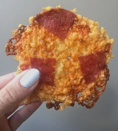 a person holding up a piece of food that looks like something out of the oven