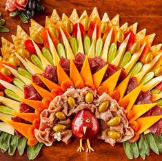 a turkey made out of fruits and veggies on top of a wooden table