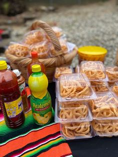 there are many food items on the table and one has ketchup in it