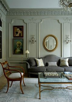 a living room filled with furniture and a chandelier