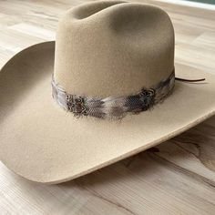 This natural-colored hat band contains rare duck feathers mixed with brown and iridescent feathers.  Natural colored feathers Adjustable hatband with Leather Laces that tie at the back. Approx. 1.25 inches wide *This product is for 1 single hat band. Hat not included. Feather Hat Band, Iridescent Feathers, Colored Feathers, Coloured Feathers, Feather Hat, Hat Band, Leather Lace, Hat Sizes, Leather And Lace