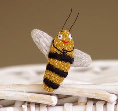 a yellow and black insect sitting on top of a white chair