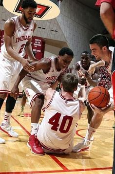 the men are playing basketball on the court