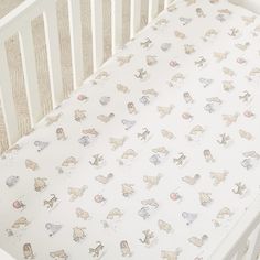 a white crib with animals on it