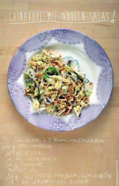 a purple plate topped with food on top of a wooden table