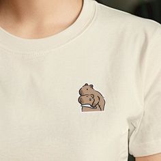 Cute capybara shirt for capybara lovers. 🧤Material: 100% preshrunk cotton, 4.2 oz./yd² (US). Soft and comfortable. 👶 Retail fit. Tear away label. 👚Size: Comes in S, M, L, XL, 2XL. 🚚 Delivery:  Delivery with the US in 3 to 7 days. ❣️Feel free to contact us with a message if you have any questions or encounter any issues. We will make it right for you :) Casual Bear Design Short Sleeve T-shirt, Casual Short Sleeve Tops With Bear Design, Capybara Shirt, Cute Capybara, Animal Lover, Beauty Book, Gender Neutral, Art Collection, Bathing Beauties