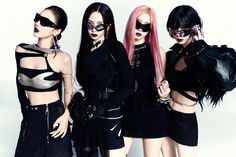 three women with pink hair and black clothes are posing for the camera while wearing sunglasses