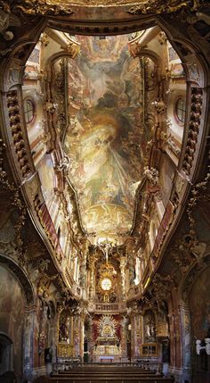 the interior of an old church with paintings on the ceiling