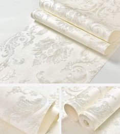 white and silver wallpaper with an ornate design on it's side, along with two