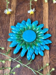 a blue flower sitting on top of a wooden table