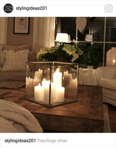 a coffee table with candles on it in a living room