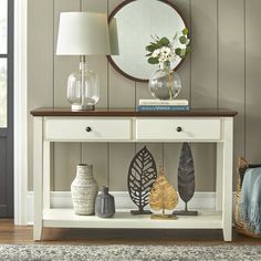 a living room with a table and mirror