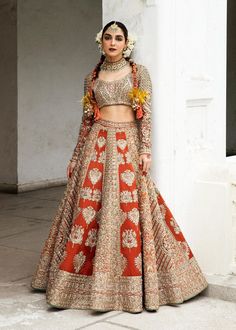 Bridal Lehenga Choli with Dupatta Indian Bridal Wear is a breathtaking masterpiece that will give you a head-turning traditional look at the wedding. Intricate designs and fine details of silverwork make this Lehenga Dress an epitome of beauty and grace. Bridal Choli The choli has a magnificent rust shade and is gracefully emblazoned with beaming adda work. Hand-crafted details of sequins, tilla, silverwork, and mukaish enhance the glamour of the choli, making it a perfect choice to pair with th Traditional Kundan Gown For Reception, Traditional Embroidered Wedding Dress For Festive Season, Traditional Kundan Gown For Ceremonies, Bollywood Wedding Dress With Intricate Embroidery For Traditional Ceremonies, Traditional Wedding Dress With Pallu For Festive Occasion, Traditional Wedding Dress For Ceremonies, Traditional Wedding Dress With Traditional Drape, Traditional Saree Wedding Dress With Intricate Embroidery, Traditional Wedding Dress With Intricate Embroidery