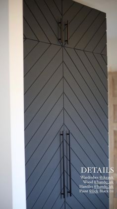 the front door is painted black and has an interesting pattern on it's side